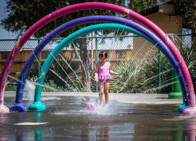 A military child beats the heat by enjoying the Fort Irwin Splash Park on 2nd Street; one of the several R2 facilities available on Fort Irwin.