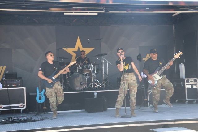 The Army’s ‘As You Were’ Band takes stage at the Miami Air and Sea Show on May 26. The band performed multiple sets during the show, entertaining the crowds in attendance. From left to right are Sgt. Arthur Abila, lead guitarist, lead vocalist Sgt.1st Class Jessica Gatlin, drummer Staff Sgt. Kenneth Goss. and bass player Staff Sgt. Abiud Flores.