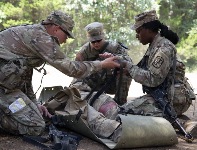 Cadet Rebecca Karis works with her fellow cadets on applying  life-saving first aid techniques to ensure battle buddy survivability on the modern battlefield during Phase II of Advance Camp at Cadet Summer Training on Fort Knox, Kentucky, July 19, 2024. They will refine their leadership tasks through land navigation, first aid, basic rifle marksmanship, hand grenade, and chemical, biological, radiological, nuclear training (U.S. Army photo by Shannon Collins). 