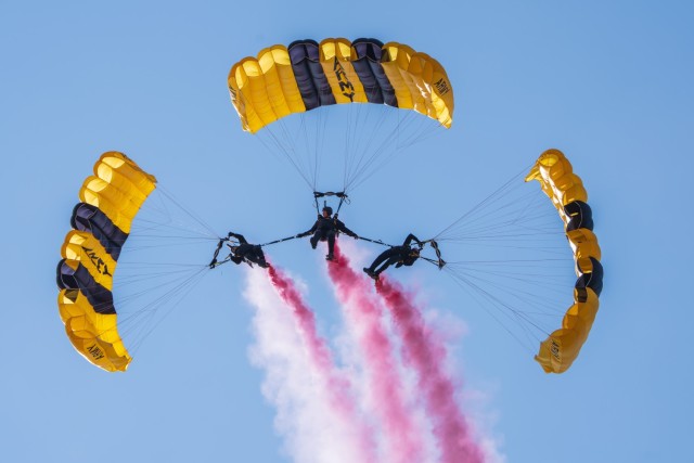 Sgt. 1st Class Rafael Torres, Sgt. 1st Class Zach Krietenstein, and Sgt. 1st Class Griffin Mueller of the U.S. Army Parachute Team fly in an advanced canopy maneuver for a parachute jump at Arctic Thunder on 19 July 2024.  The parachute demonstration was part of the Arctic Thunder Open House Air Show on Joint Base Elmendorf Richardson, Alaska.