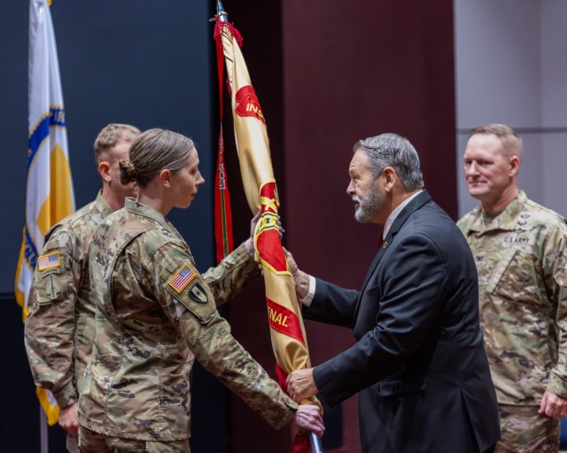 Davis Tindoll, director of the Installation Management Command-Sustainment, passes the Garrison’s colors to Col. Erin Eike who assumed command during a ceremony Aug. 1 in Bob Jones Auditorium.