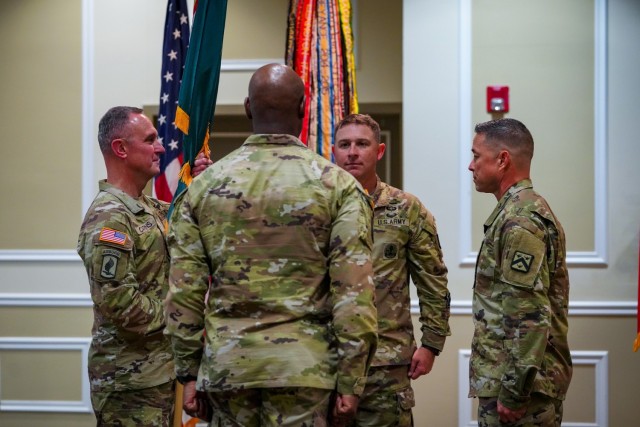 FORT LEAVENWORTH, Kansas, 240806-A-OD829-1014-- (From left to right) Incoming U.S. Army Combined Arms Center (CAC) Command Sgt. Maj. Shawn F. Carns takes the unit colors during a change of responsibility ceremony at the Frontier Conference Center...