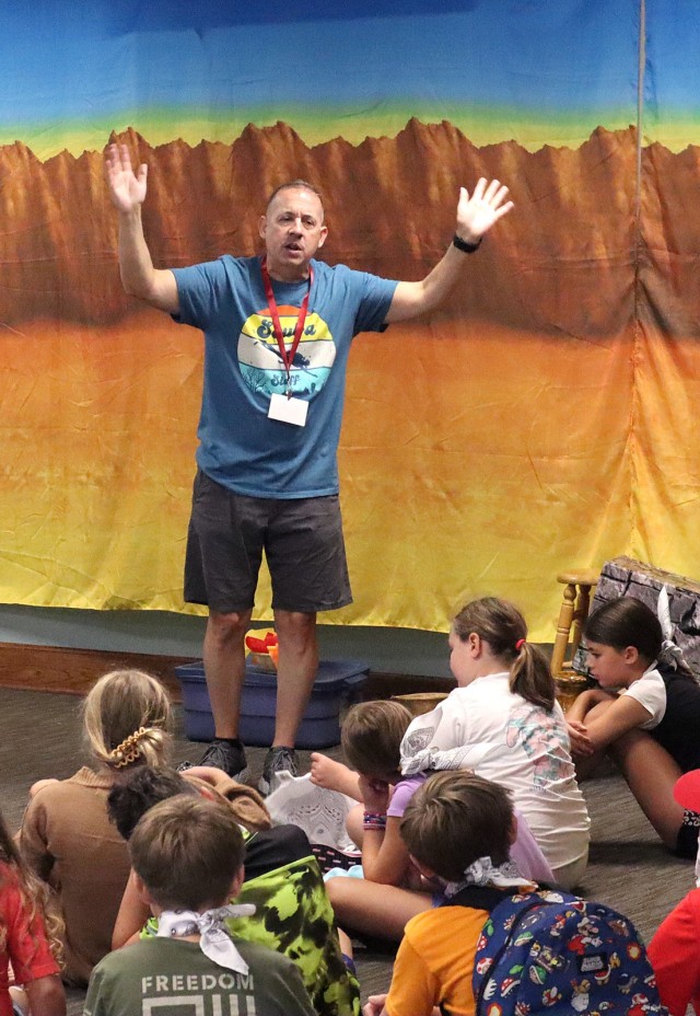 Fort Leavenworth Garrison Chaplain (Lt. Col.) Nathan McLean talks with Vacation Bible School participants about scripture during the first day of VBS’s faith-based education and activities Aug. 6, 2024, at Pioneer Chapel on Fort Leavenworth,...