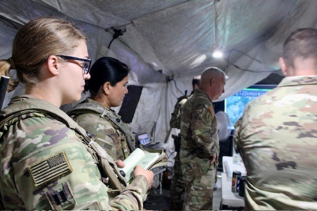 Advisors in the tactical operations center (TOC) receiving a brief