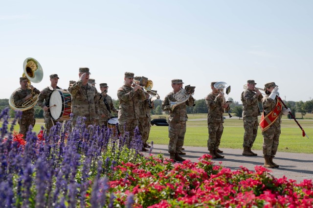 399th Army Band Commander and Bandmaster Chief Warrant Officer 4 Jared DeLaney (front left) and Drum Major 1st Sgt. Jennifer Champagne (far right) render salute as the band plays during a change-of-command ceremony for 169th Engineer Battalion...