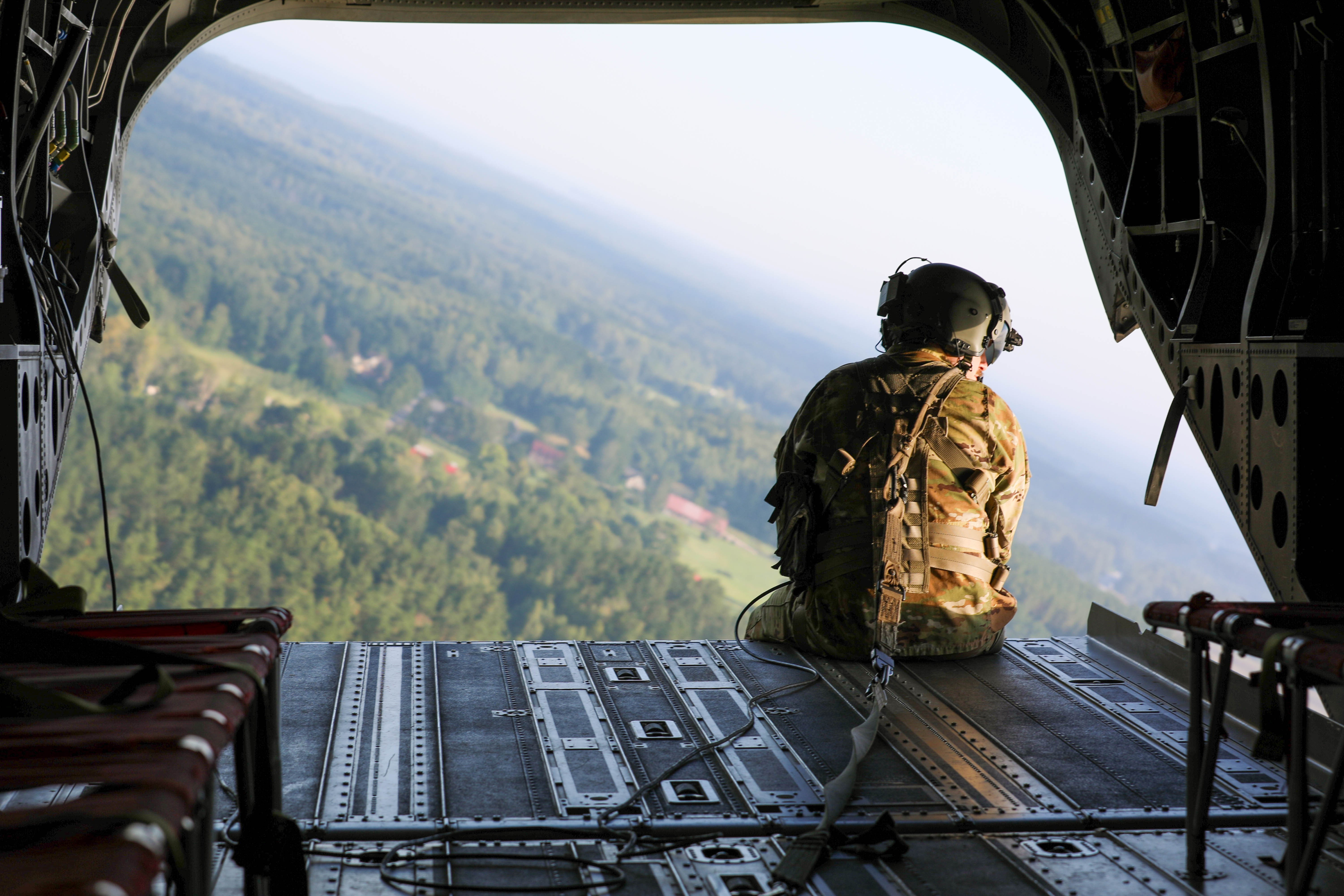 U.S. Army Staff Sgt. Jacob Centers, a CH-47 Chinook crew chief assigned to 2nd General Support Aviation Battalion, 227th Aviation Regiment, 1st Air Cavalry Brigade, 1st Cavalry Division, sits on the ramp of the helicopter during exercise Paladin...