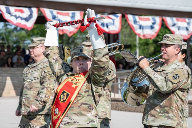 Drum Major 1st Sgt. Jennifer Champagne (front center) leads the 399th Army Band as they march in front of the reviewing stand during a change-of-command ceremony for 169th Engineer Battalion Aug. 9 on Gammon Field. This is the final review...