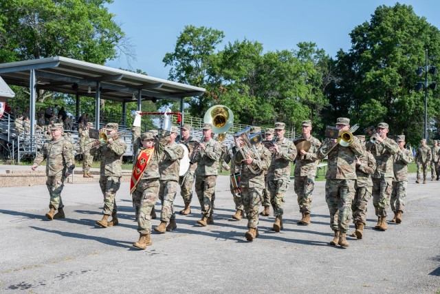 The 399th Army Band, led by Drum Major 1st Sgt. Jennifer Champagne, marches past the reviewing stand during a change-of-command ceremony for 169th Engineer Battalion Aug. 9 on Gammon Field. The band’s presence represents the significant role the...