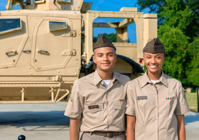 Pvt. Darrin Jackson and Pvt. Michanti Jackson, pose together after graduating Infantry One Station Unit Training Aug. 9, 2024, on Inouye Field at the National Infantry Museum in Columbus, Georgia.