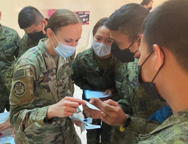 Maj. Kelly Spencer, 5th Security Force Assistance Brigade Nurse and Medical Advisor, discusses the use of Eldon blood-typing cards with medics and nurses from the Philippine Army. The hands-on training was part of a class on fresh whole blood transfusion at the point of injury during Salaknib &#39;22 at Fort Magsaysay, Philippines, Mar. 14, 2022.