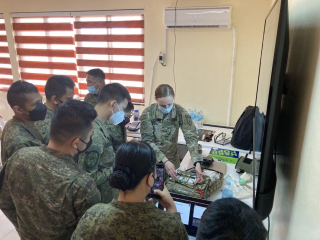 The 5th Security Force Assistance Brigade Nurse, Maj. Kelly Spencer demonstrates medical aid bag packing for members of the Philippine Army at Fort Magsaysay, Philippines, Mar. 14, 2022. This portion of the bilateral training between 5th SFAB Medical Advisors and the Philippine Army emphasized Tactical Combat Casualty Care best practices during Salaknib &#39;22.