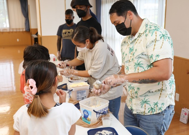 Soldiers from the 38th Air Defense Artillery Brigade serve ice cream to residents of the Sagamihara Minami Children's Home during an exchange event in Sagamihara, Japan, Aug. 14, 2024. The event allowed the soldiers to help the residents share their...