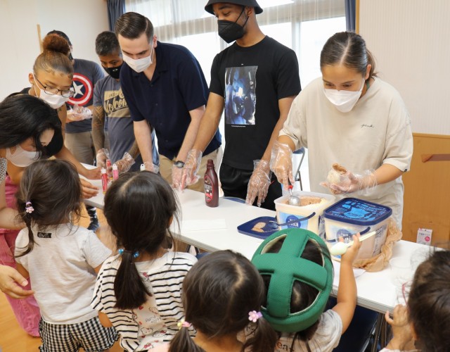 Soldiers from the 38th Air Defense Artillery Brigade serve ice cream to residents of the Sagamihara Minami Children's Home during an exchange event in Sagamihara, Japan, Aug. 14, 2024. The event allowed the soldiers to help the residents share their...