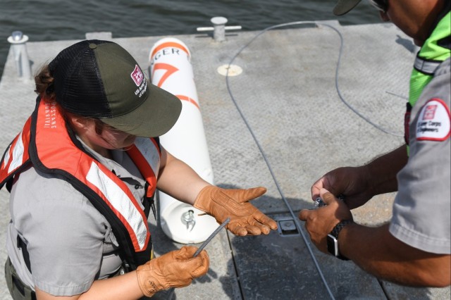 USACE Rangers place buoys on Lake Barkley to warn boaters of shallow water