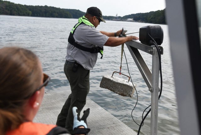 USACE Rangers place buoys on Lake Barkley to warn boaters of shallow water