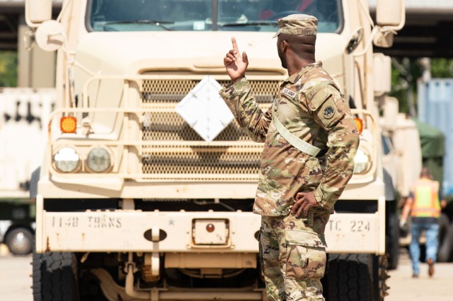 U.S. Army Sgt. Maasai Bandele, a motor sergeant with the Fort Eisenhower-based 1148th Transportation Company, 110th Combat Sustainment Support Battalion, 78th Troop Command, Georgia Army National Guard, points towards a M915A5 line-haul tractor...