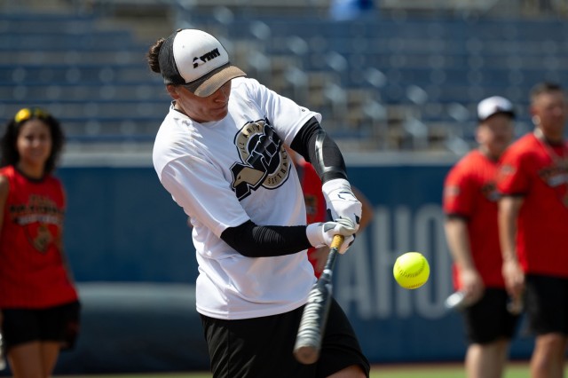 Army Sgt. Melina Wilkinson hits a home run in the home run derby competition at the start of the Armed Forces Men’s and Women’s Softball Championship hosted by USA Softball at Devon Park in Oklahoma City, Aug. 13, 2024.