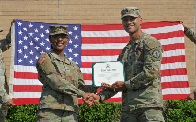 Sergeant Destiny Coleman of Headquarters and Headquarters Company, 89th Military Police Brigade, poses with First Lt. Andrew Quintero following her reenlistment ceremony at 89th Military Police Brigade Headquarters, Fort Cavazos, Texas, March 13.