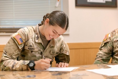 Spc. Mandy Kiddy signs her University of Oklahoma Army ROTC contract Aug. 23, 2024, on Fort Moore, Ga.