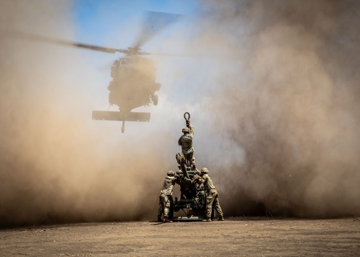 U.S. Army artillerymen with 3rd Battalion, 7th Field Artillery Regiment, 25th Division Artillery, 25th Infantry Division, prepare for the helicopter to sling load a M119 A3 105mm howitzer during Super Garuda Shield 2024 at Puslatpur 5, Indonesia