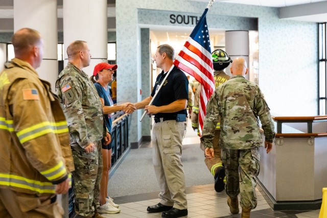 Jeremy Evett, Fort Novosel Fire Chief, shakes hands with Fort Novosel community members during the 9/11 Memorial Stair Climb inside Bldg. 5700 on Fort Novosel Sept. 6, 2024.