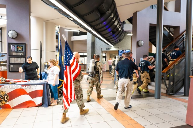 LTC Tom Burch, Director of Public Safety, carries the American Flag during the 9/11 Memorial Stair Climb inside Bldg. 5700 on Fort Novosel Sept. 6, 2024.