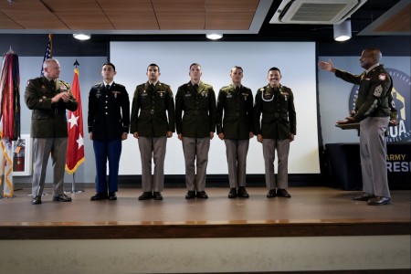 Winners of the Army Reserve Best Squad Competition, 1st Mission Support Command Soldiers Sgt. Nelson Medina, Sgt. Edgardo Santiago, Spc. Abel Bonilla, Spc. Angel Machado, and Spc. Elvin Rivera, stand on stage to accept their awards at Joint Base...