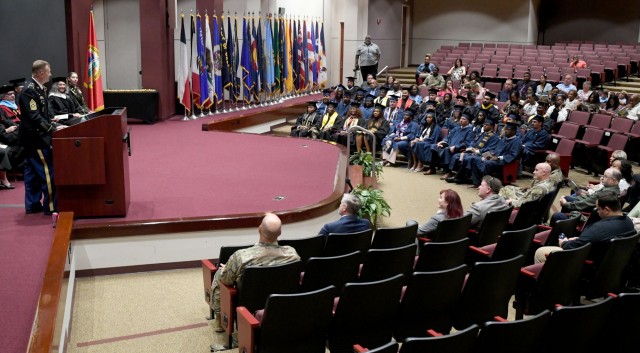 Garrison Command Sgt. Maj. Dylan Lemasters delivers the commencement address at Redstone Arsenal’s Combined College Graduate Recognition Ceremony.