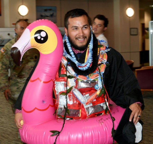 Juan Munoz, who graduated from Embry-Riddle Aeronautical University with a bachelor of science in project management, celebrates in a pink flamingo after the Combined College Graduate Recognition Ceremony on Sept. 4 at Bob Jones Auditorium.