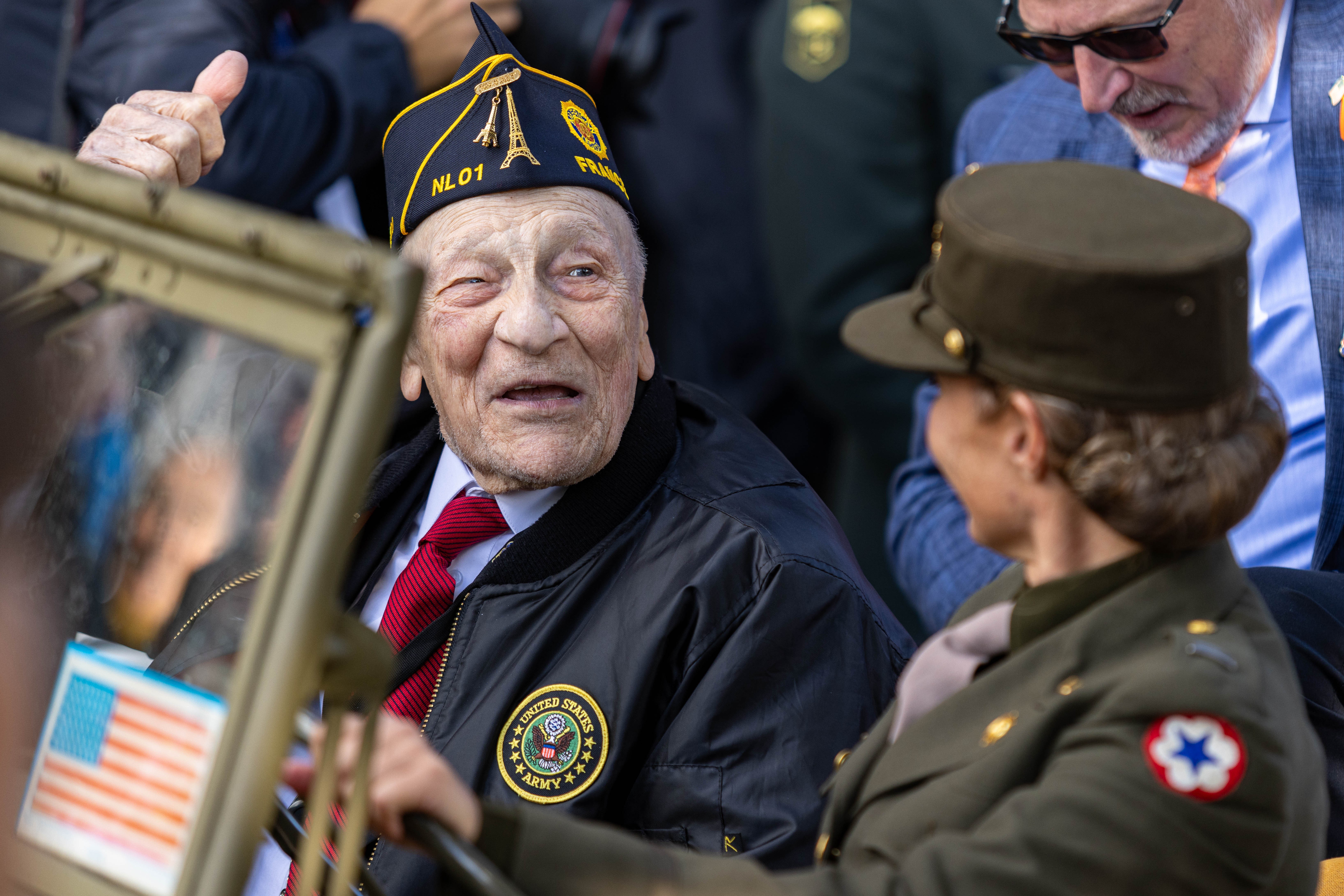 A World War II veteran gives a thumbs-up as he rides in a vintage U.S. Army Jeep during the opening ceremony for the 80th anniversary commemoration of Operation Market Garden in Mesch, the Netherlands, Sep. 12, 2024. The veterans were honored...