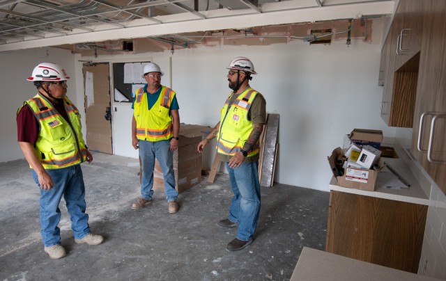 David Patterson, right, and Robert "Alex" Espinoza, left, both construction representatives with the U.S. Army Corps of Engineers' West Texas Area Office, meet with the onsite construction company's safety representative to inspect renovations at...