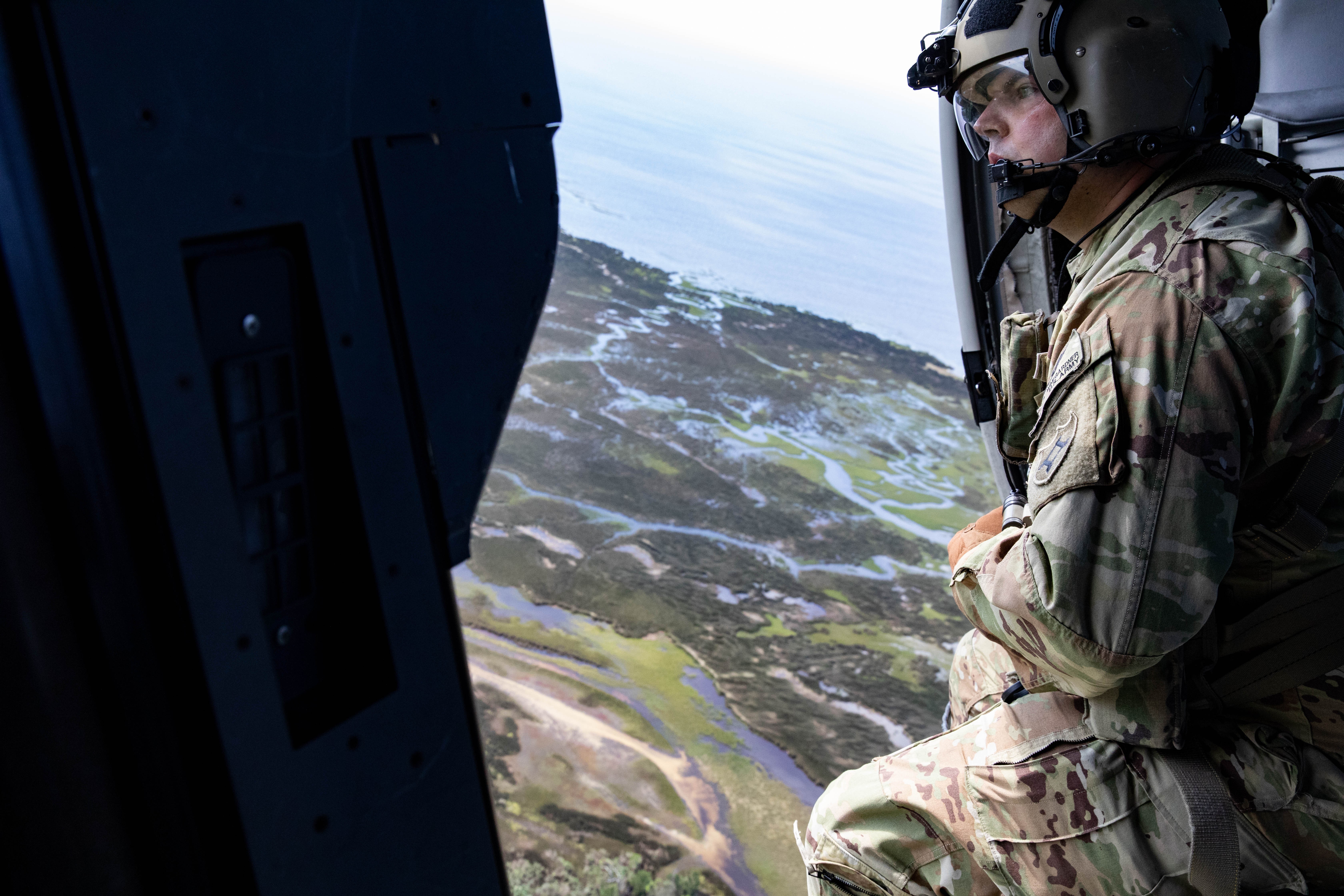 Sgt. Justin Wingarder, a crew chief from the Florida Army National Guard’s 1st Battalion, 111th Aviation Regiment, conducts a search and rescue mission in an HH-60 Blackhawk helicopter outside Tallahassee International Airport on Friday, Sept....