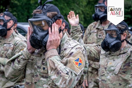 U.S. Army Spc. James Collins, 10th Army Air and Missile Defense Command, secures his mask during a comprehensive CBRN training held by Headquarters and Headquarters Battery on May 31, 2024, in Landstuhl, Germany.