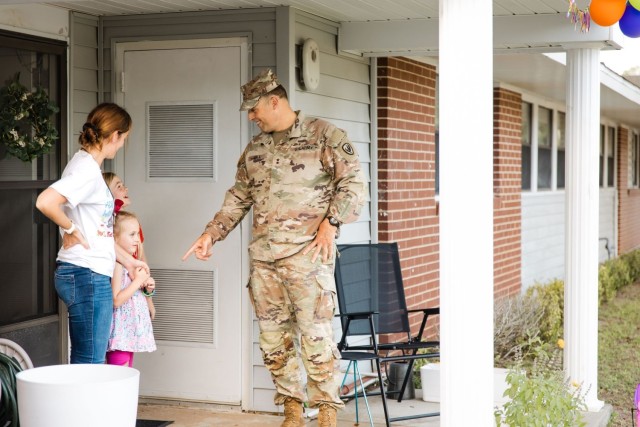 Maj. Gen. Clair A. Gill, U.S. Army Aviation Center of Excellence and Fort Novosel commander, surprises Allen Heights resident Tiffanie Burgess by stopping to say happy birthday to her daughter during the walking town hall Oct. 2.