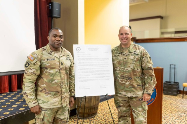 Col. John P. Miller and Command Sgt. Maj. Gary J. Williams sign the 2024 Domestic Violence Awareness Proclamation on Fort Novosel.