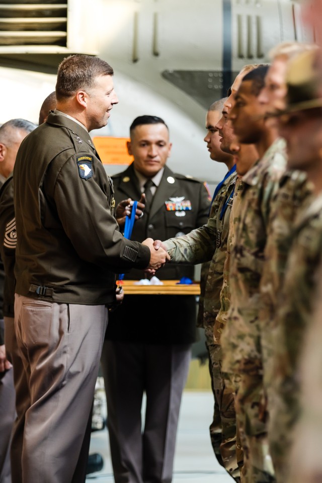 Maj. Gen. Clair A. Gill, commanding general of the United States Army Aviation Center of Excellence and Fort Novosel, awards medals to the winners of the Iron Squad Challenge, an event to commemorate the 31st anniversary of the Battle of Mogadishu...