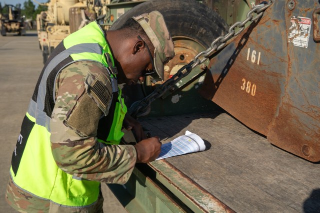 U.S. Army Sergeant Jonathan Haygood with the 3rd Expeditionary Sustainment Command writes down a truck's identification numbers for 20th Enginnering Brigade's vehicles at Fort Libery, North Carolina, October 4, 2024. The 20th Engineering...