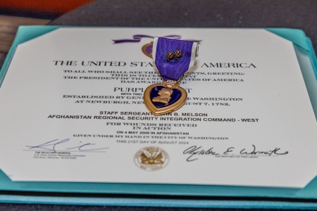 The Purple Heart Medal awarded to Sergeant Major John B. Melson, 1st Battalion, 54th Security Force Assistance Brigade, rests atop the certificate presented during a recognition ceremony Sept. 25, 2024. The award recognizes Mel...
