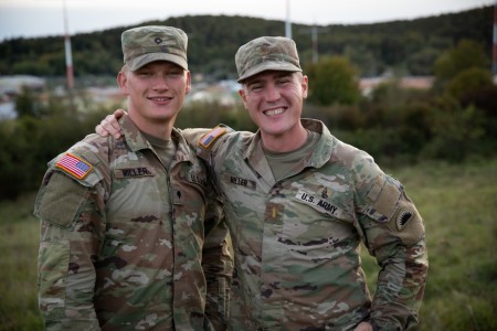 U.S. Army Spc. Markian Miller, left, and 2nd Lt. Lincoln Miller pose for a photo during Kosovo Force training at the Joint Multinational Readiness Center, Hohenfels, Germany, Sept. 29, 2024. Kosovo Force, also known as KFOR, includes 28 NATO...