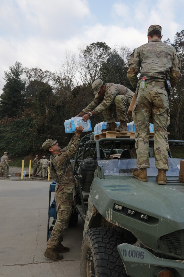 U.S. Army Soldiers with the 264th Combat Sustainment Support Battalion (CSSB), 161st Infantry Regiment and 82nd Airborne Division Bravo Company under the command of the 264th CSSB, 1LT Dora Castillo, load supplies onto an infantry squad vehicle...