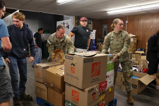 Soldiers assigned to 20th Engineer Brigade, XVIII Airborne Corps, help organize supplies at the Eastern Board of Cherokee Indians Tribal Foods Distribution in Cherokee, N.C., Oct. 7, 2024. The XVIII Airborne Corps are working side-by-side with...