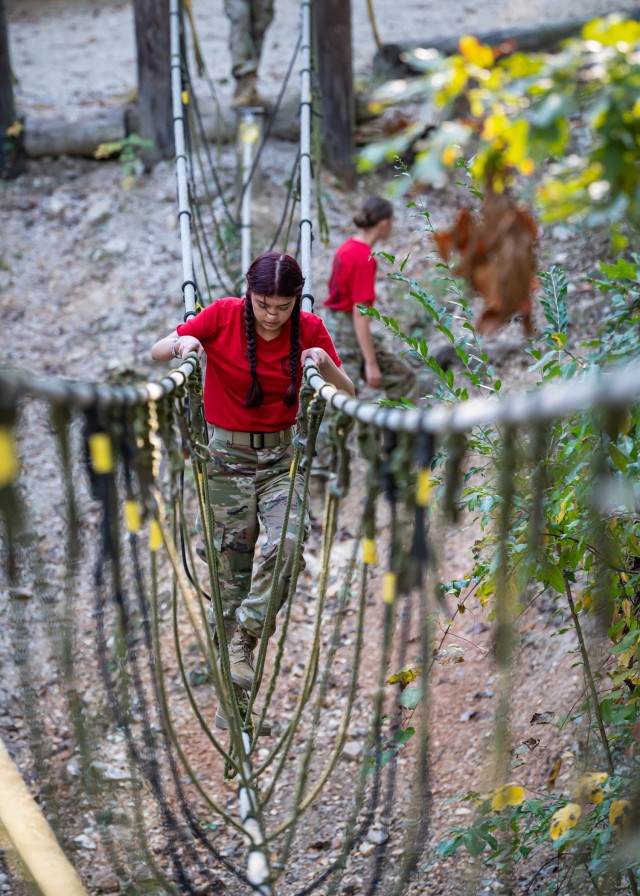 Audrey Dyer, a junior cadet with the Junior ROTC program at Scott Regional Technology Center in Monett, Missouri, crosses the rope bridge during the Physical Endurance Course portion of the Waynesville Junior ROTC Survival of the Fittest Raider...