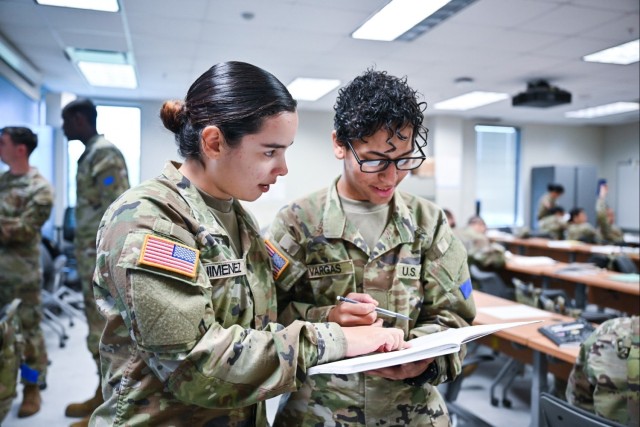 Two Future Soldier Preparatory Course students compare notes during a study hall session at Fort Jackson, South Carolina. The course is helping America’s youth overcome academic and physical fitness barriers to service.