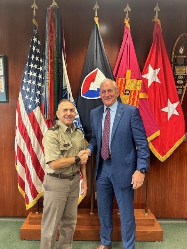 Maj. Gen. Michael B. Lalor, commanding general of TACOM, and retired Gen. Robert B. Brown, president of AUSA, shake hands following a recording of “In General Terms.”