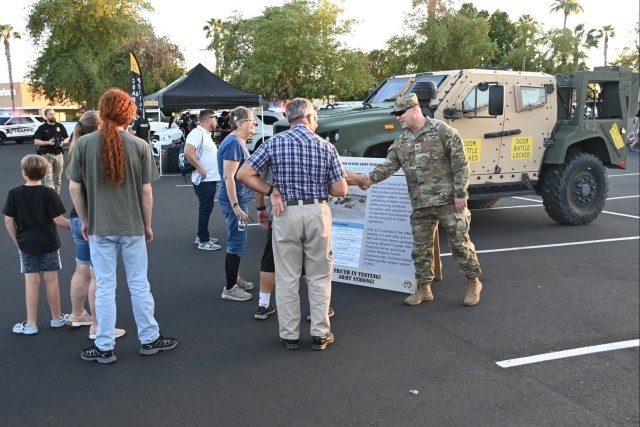 U.S. Army Yuma Proving Ground Commander Col. John Nelson (right) greets eventgoers at the Yuma Police Department&#39;s annual Getting Arizona Involved in Neighborhoods (GAIN) at Yuma Palms Mall on October 12, 2024. The proving ground has supported...