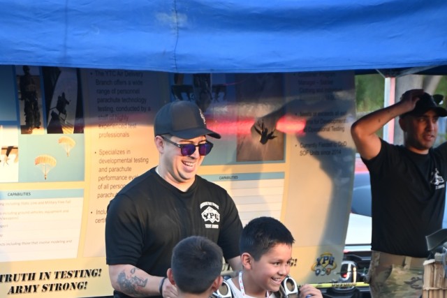Youngsters at the Yuma Police Department&#39;s annual Getting Arizona Involved in Neighborhoods (GAIN) at Yuma Palms Mall on October 12, 2024 try on parachutes and gear used by the Soldiers of Yuma Proving Ground&#39;s elite Airborne Test Force....