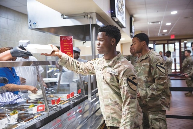 Pfc. Ishmiel Williams, 2nd Battalion, 7th Cavalry Regiment, 3rd Armored Brigade Combat Team, receives his lunch at the Headquarters Department of the Army Go for Green Action Station Oct. 9, 2024, at the Operation Iraqi Freedom Dining Facility at Fort Cavazos.