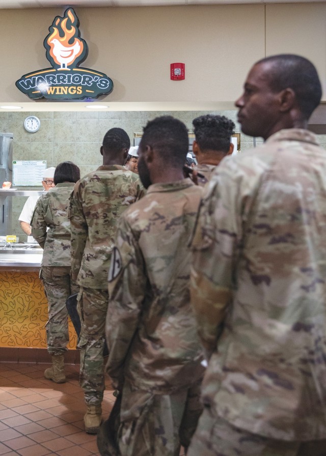 Soldiers line up at the &#34;Warrior&#39;s Wings&#34; station at the Headquarters Department of the Army Go for Green Action Station to receive their lunch Oct. 9 at the Operation Iraqi Freedom Dining Facility at Fort Cavazos