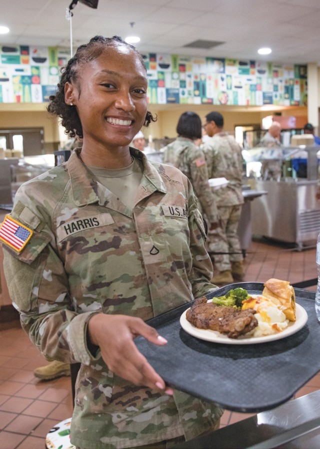 Pfc. Sieria Harris, 215th Brigade Support Battalion, poses with her steak, mashed potatoes, broccoli and roll she picked from the Headquarters Department of the Army Go for Green Action Station Oct. 9, 2024, at the Operation Iraqi Freedom Dining Facility at Fort Cavazos.