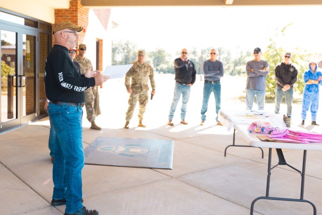 Sam Baker, 110th Aviation Brigade S3, speaks to participants in the 7th annual post-wide motorcycle ride for cancer Oct. 18 on Fort Novosel.